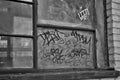 Close up of a broken boarded up window and sill with peeling paint and graffiti Royalty Free Stock Photo