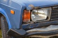 broken blue car with broken headlight and wing on the car is dented. Royalty Free Stock Photo