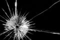 Close up of broken, cracked pane of glass with bullet hole, on black background with copy space Royalty Free Stock Photo