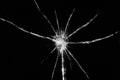 Close up of broken, cracked pane of glass with bullet hole, on black background with copy space Royalty Free Stock Photo