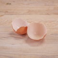 Close up of broken eggshell on wooden table Royalty Free Stock Photo