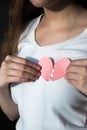 Close-up of broken heart held against woman`s chest Royalty Free Stock Photo