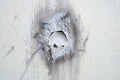 Close up of a broken hole in the cement wall of a building Royalty Free Stock Photo