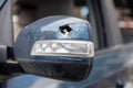 Close up broken left side rearview mirror of a car in blue. Auto insurance concept. Broken side glass of the car on the driver`s Royalty Free Stock Photo