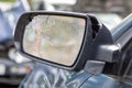 Close up broken left side rearview mirror of a car in blue. Auto insurance concept. Broken side glass of the car on the driver`s Royalty Free Stock Photo