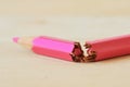 Close-up of broken pink colored pencil - Concept of violence against women Royalty Free Stock Photo