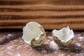 Close up. Broken quail egg shell on the background of brown wooden board. Copy space Royalty Free Stock Photo