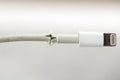 Close up of broken smart phone charger cable on light background Royalty Free Stock Photo