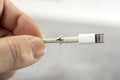 Close up of broken smart phone charger cable on light background Royalty Free Stock Photo
