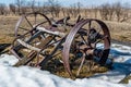 Close up of broken steel wagon wheels in a field in Saskatchewan Royalty Free Stock Photo