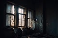close-up of broken windows in abandoned building, with eerie light shining through Royalty Free Stock Photo