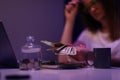 Broken young woman counting cash money, glass container with coins on desk