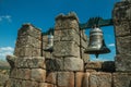 Close-up of bronze bells on top of stone brick wall Royalty Free Stock Photo