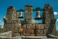 Close-up of bronze bells on top of stone brick wall Royalty Free Stock Photo