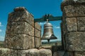 Close-up of bronze bells on top of stone brick wall Royalty Free Stock Photo