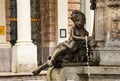 Close-up of a bronze sculpture of a young child drinking from a fountain in Bratislava