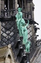 Close-up on bronze statues of the apostles at the base of the spire on the Notre Dame cathedral at Paris