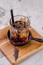 Close up, brown alcoholic cocktail with whiskey, ice cubes decorations on a wooden board, gray background. Bar alcohol Royalty Free Stock Photo
