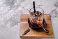 Close up, brown alcoholic cocktail with whiskey, ice cubes decorations on a wooden board, gray background. Bar alcohol Royalty Free Stock Photo