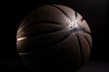 Close-up of a brown basketball against a black background. Sport equipment Royalty Free Stock Photo