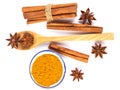 Close up the brown cinnamon stick and powder with star anise spice in wooden spoon isolated on white background Royalty Free Stock Photo