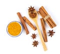 Close up the brown cinnamon stick and powder with star anise spice in wooden spoon isolated on white background Royalty Free Stock Photo