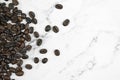 Close up, brown coffee beans on a marble pattern background with copy space. Top view Royalty Free Stock Photo