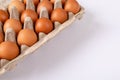 Close-up of brown eggs in egg carton on table with blank space Royalty Free Stock Photo