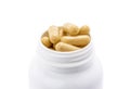 Close-up of brown herbal supplement capsules for health inside white plastic bottle Royalty Free Stock Photo
