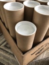 Close up of brown mailer tubes with white plastic caps