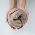 Close-up of brown merino wool ball in hands Royalty Free Stock Photo