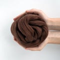 Close-up of brown merino wool ball in hands Royalty Free Stock Photo