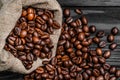 Close-up of brown organic coffee beans falling from the bag Royalty Free Stock Photo