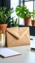 Close-up of brown paper envelope on a white desk with plants in the background Royalty Free Stock Photo