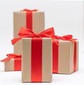 Close-up brown paper gift box red bow ribbon white background. concept for happy love gift Royalty Free Stock Photo