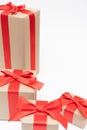Close-up brown paper gift box red bow ribbon white background. concept for happy love gift Royalty Free Stock Photo