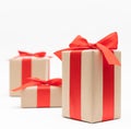 Close-up brown paper gift box red bow ribbon white background. concept for happy love gift Royalty Free Stock Photo