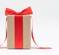 Close-up brown paper gift box red bow ribbon white background. concept for happy love gift Royalty Free Stock Photo