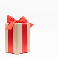 Close-up brown paper gift box red bow ribbon white background. concept for happy love gift Royalty Free Stock Photo