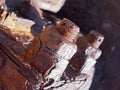 close up of brown rusted threaded bolts and nuts on old corroded machinery