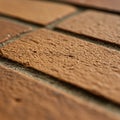 Close-up of brown textured bricks arranged in a straight pattern. The surface of the Royalty Free Stock Photo