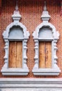 Brown wall and old windows concrete frame with wood patterns inside on temple background