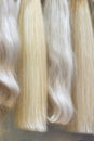 Close up brown, white and another color of hair wigs display in beauty salon. Royalty Free Stock Photo