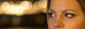 Close up of a brown woman eyes night lights bokeh. Royalty Free Stock Photo