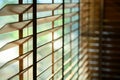 Close-up brown wooden blinds. lighting range control sunlight coming from a window. decoration interior. Modern jalousie Royalty Free Stock Photo