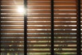 Close-up brown wooden blinds. lighting range control sunlight coming from a window. decoration interior. Modern jalousie Royalty Free Stock Photo