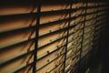 Close-up brown wooden blinds. lighting range control sunlight coming from a window. decoration interior. Modern jalousie Royalty Free Stock Photo