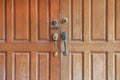 Close up brown wooden door with key lock and handle Royalty Free Stock Photo