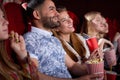 Brunette Arabian man and blonde smiling woman in cinema. Royalty Free Stock Photo