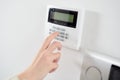 Close up on brunette woman's hand entering code on keypad